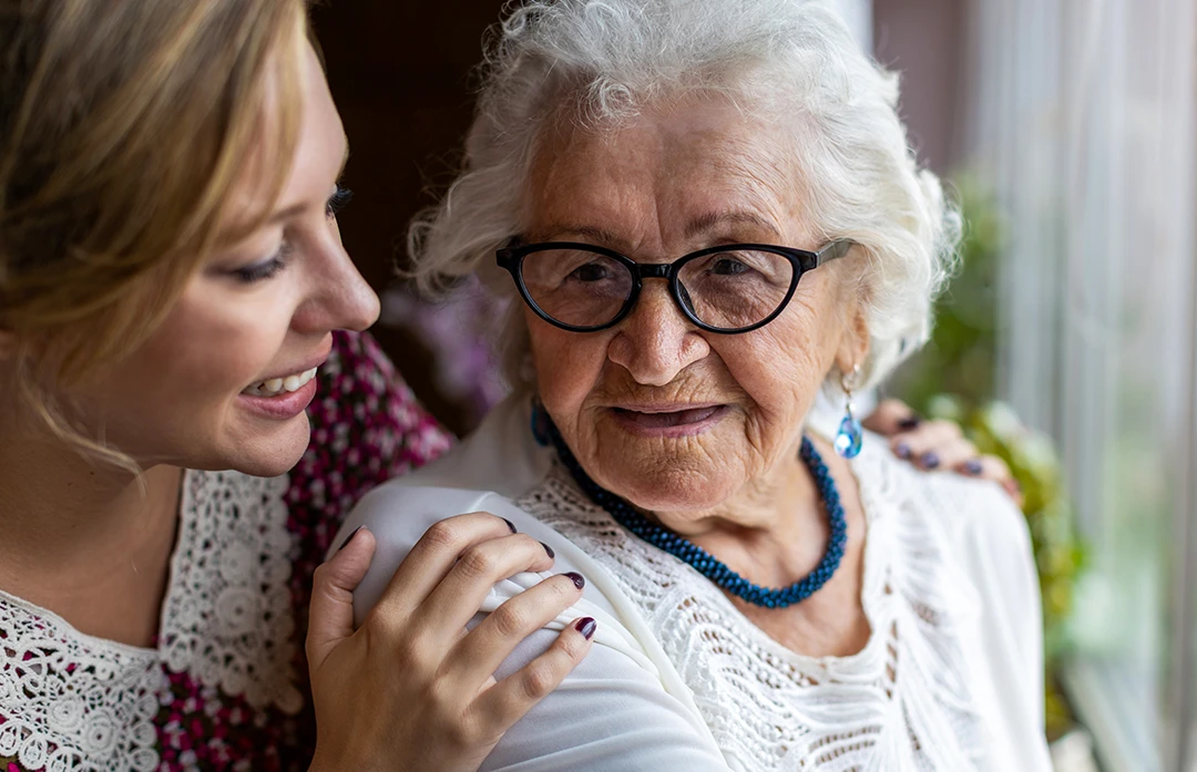 Mature-age Daughter smiling, talking with elderly mother about Functional Incontinence